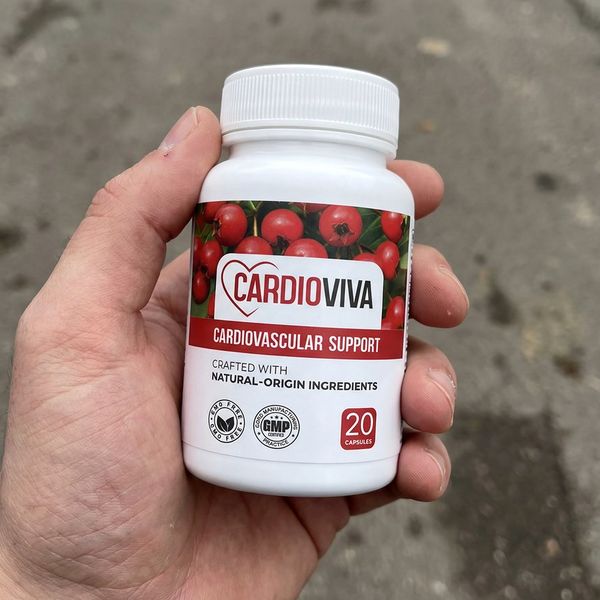 Biela fľaštička CardioViva s vrúbkovaným uzáverom v dlani, v pozadí sivý asfalt, na etikete údaj 20 kapsúl
